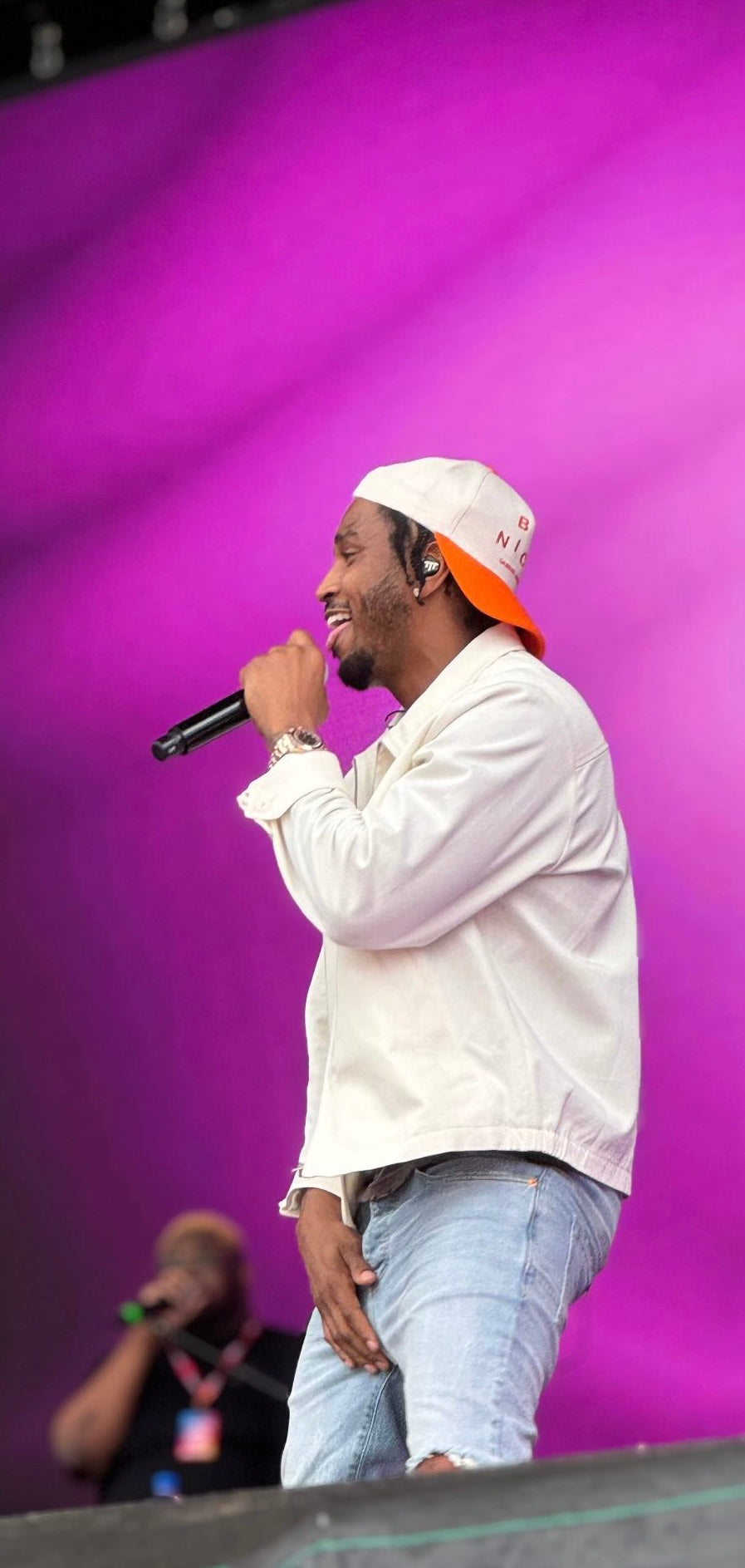 Trey Songz wearing a orange gabriel abera be nice cap at jucie fest in new zealand australia
