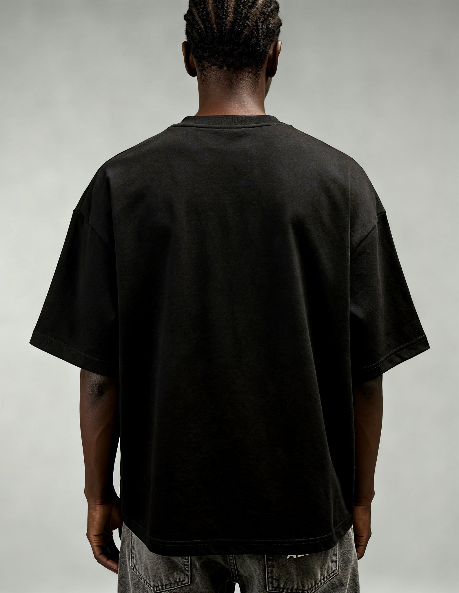 Back view of black oversized streetwear T-shirt by GABRIEL ABERA with clean minimal design and relaxed fit.