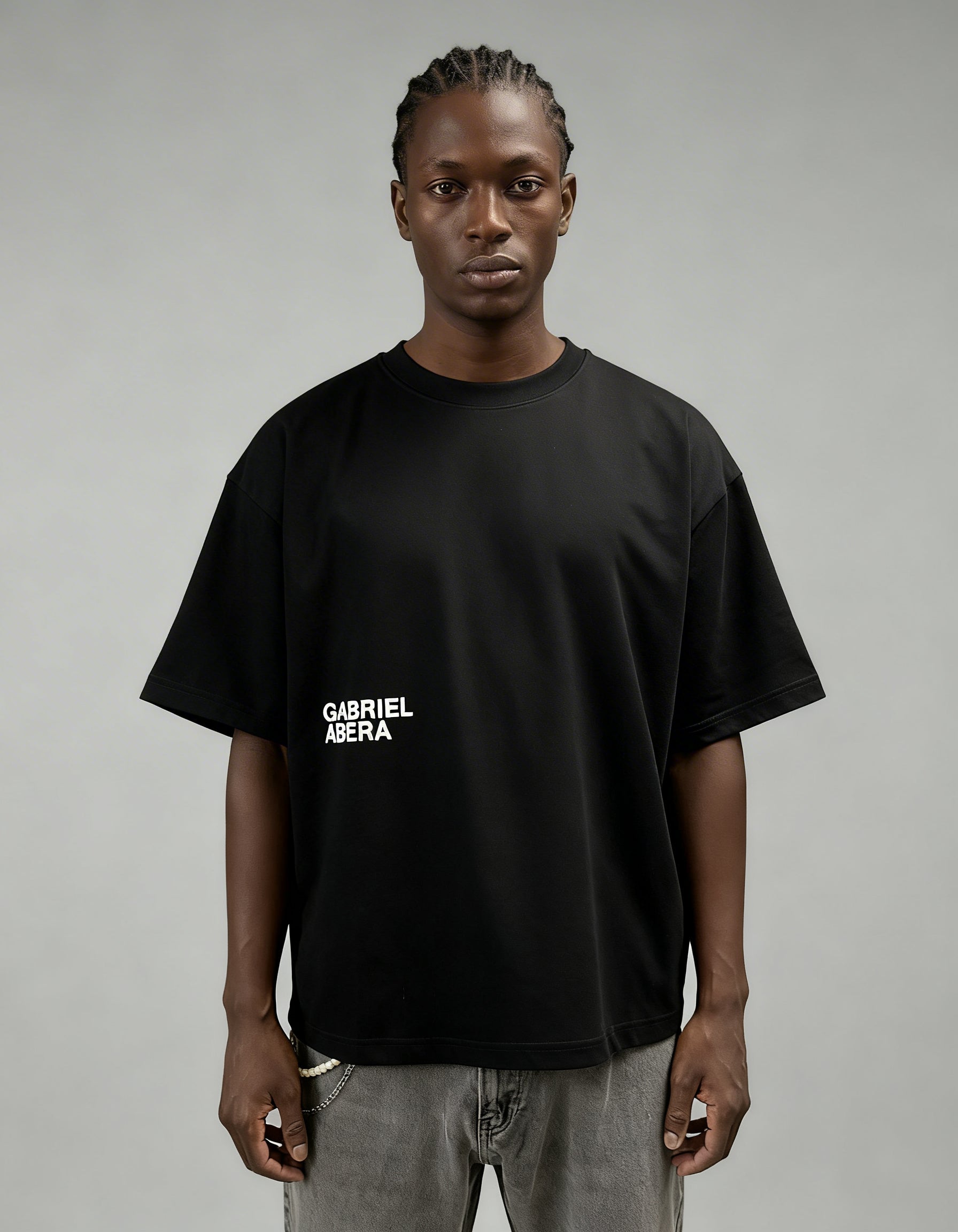 Black boxy oversized T-shirt by GABRIEL ABERA with minimal white logo print on the front.