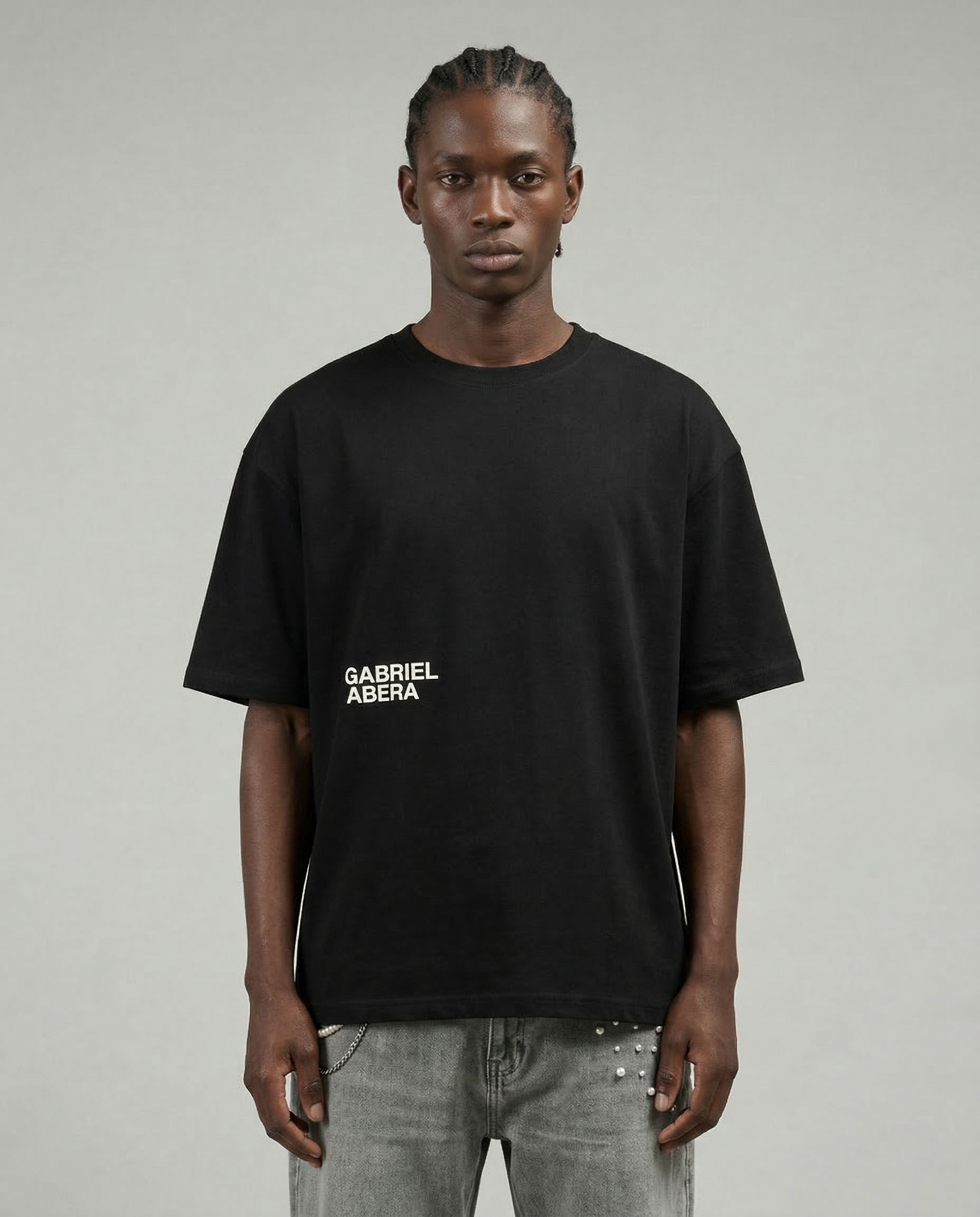Black oversized logo T-shirt by GABRIEL ABERA worn by male model showing relaxed boxy fit.