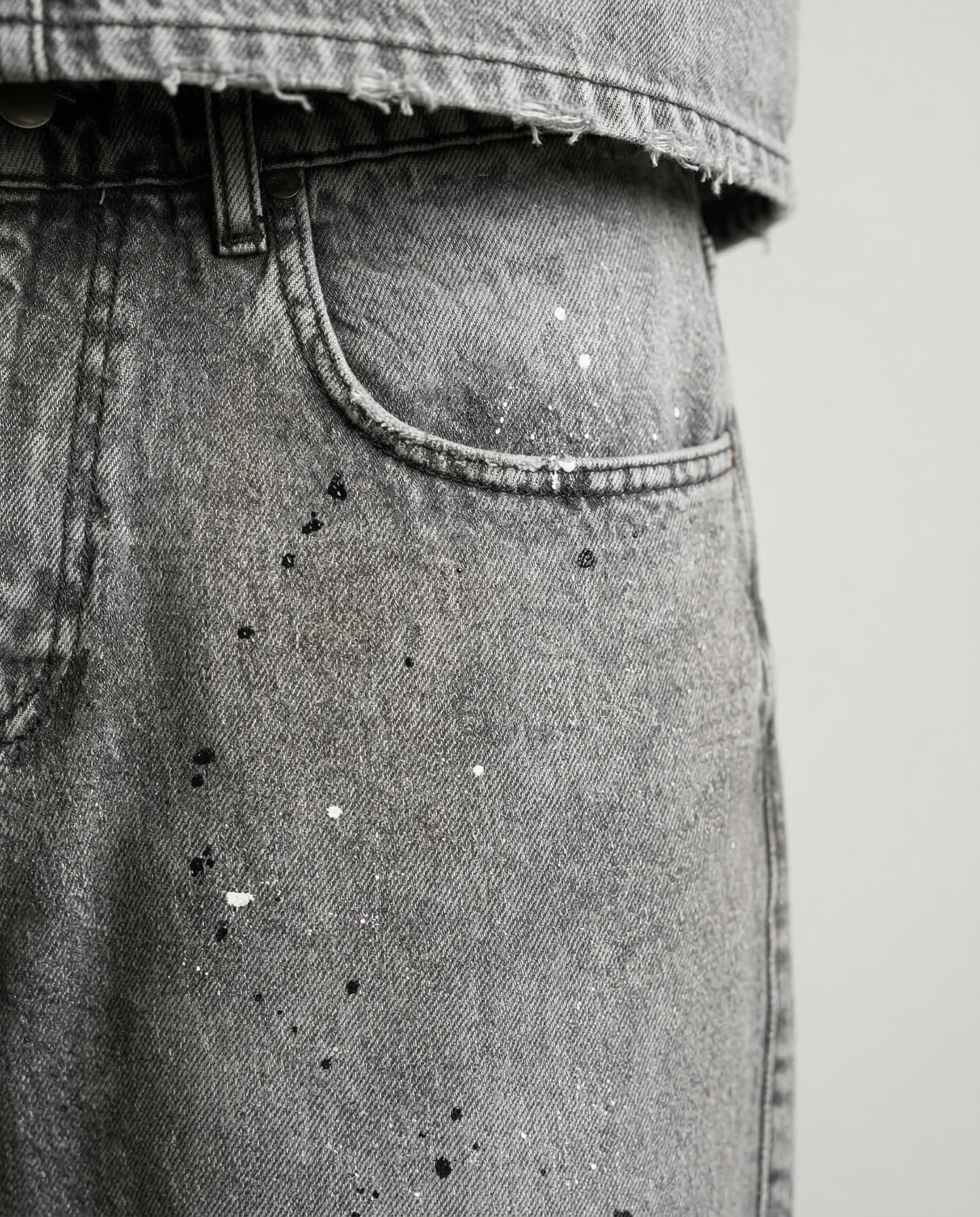 Close-up of paint splatter detail on Gabriel Abera Paint Splattered Denim Shorts