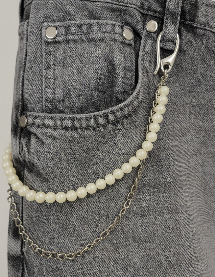 Detail of decorative chain attached to grey rhinestone denim jeans by GABRIEL ABERA.