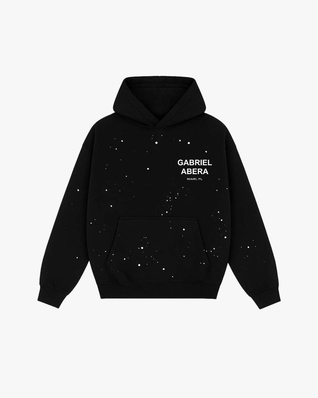 GABRIEL ABERA Splattered Puff Hoodie Black/White – Frontansicht mit weißen sowie farbigen Spritz-Effekten