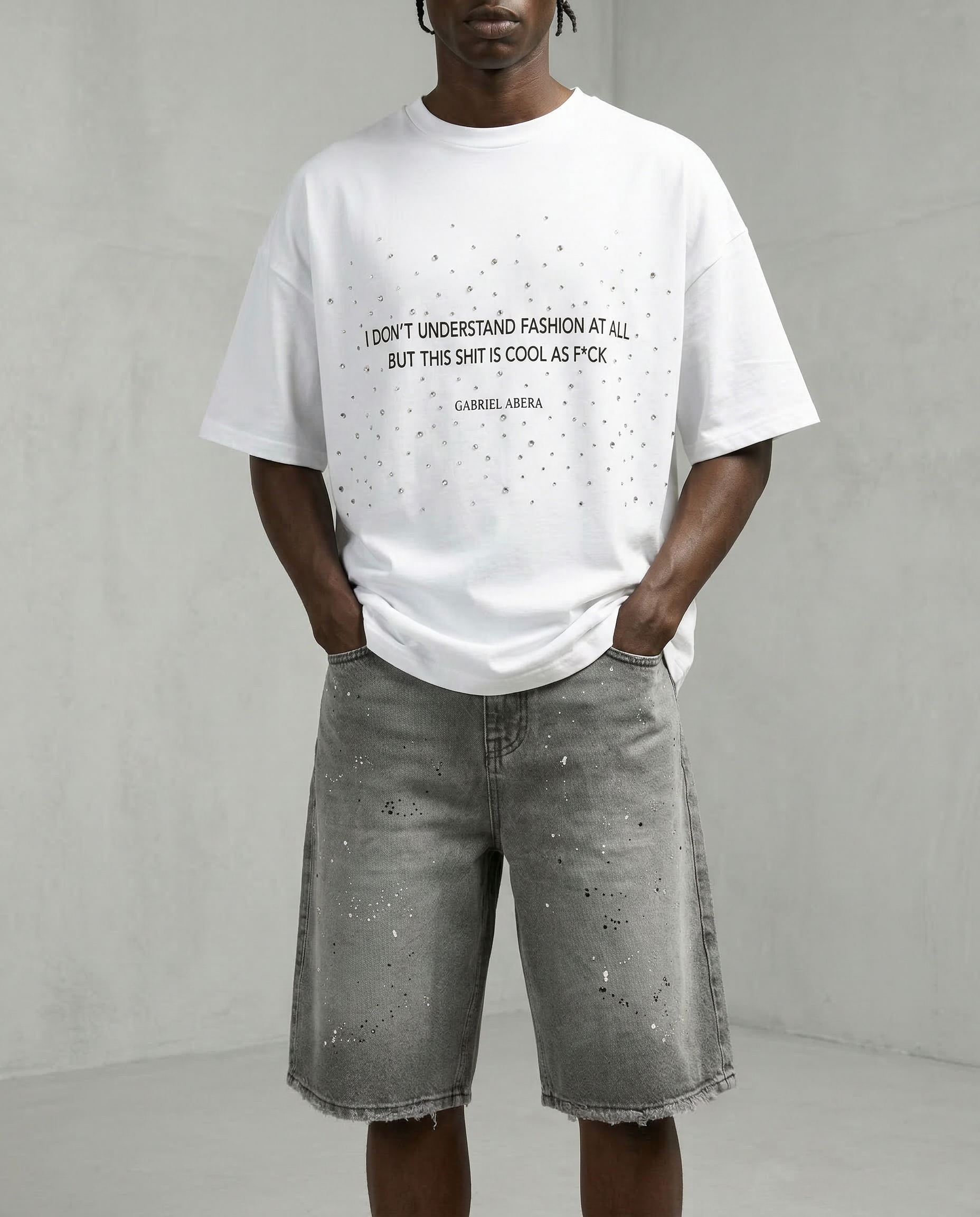 Front view of male model wearing Gabriel Abera paint Splattered Denim Jorts, cropped at waist