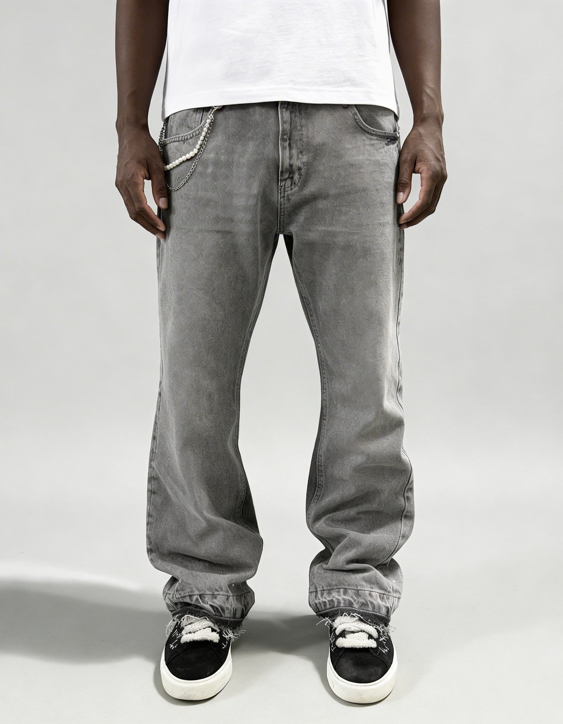 Grey rhinestone denim jeans by GABRIEL ABERA with loose streetwear fit and stonewashed grey fabric featuring rhinestone embellishments and chains.