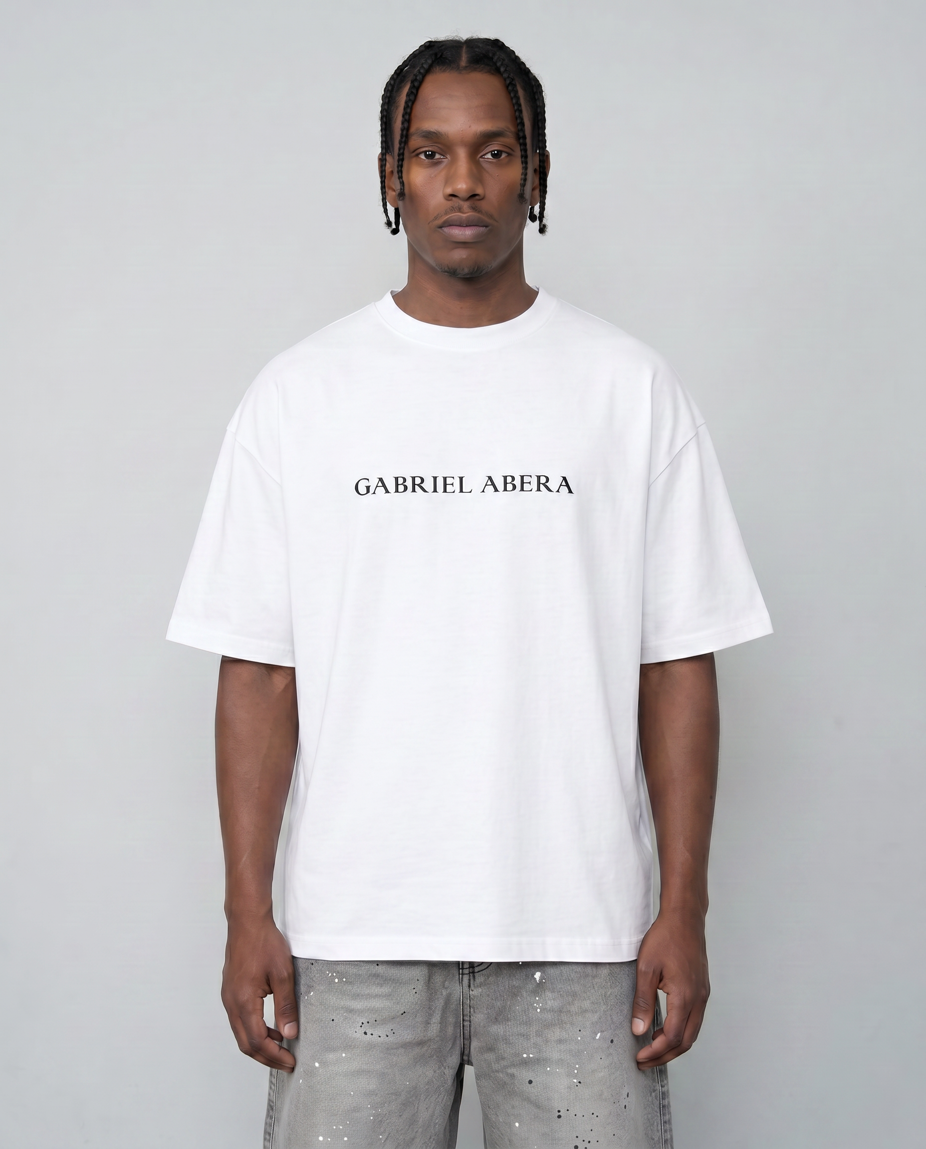 Male model wearing cream white oversized t-shirt front view with dropped shoulders and relaxed streetwear fit