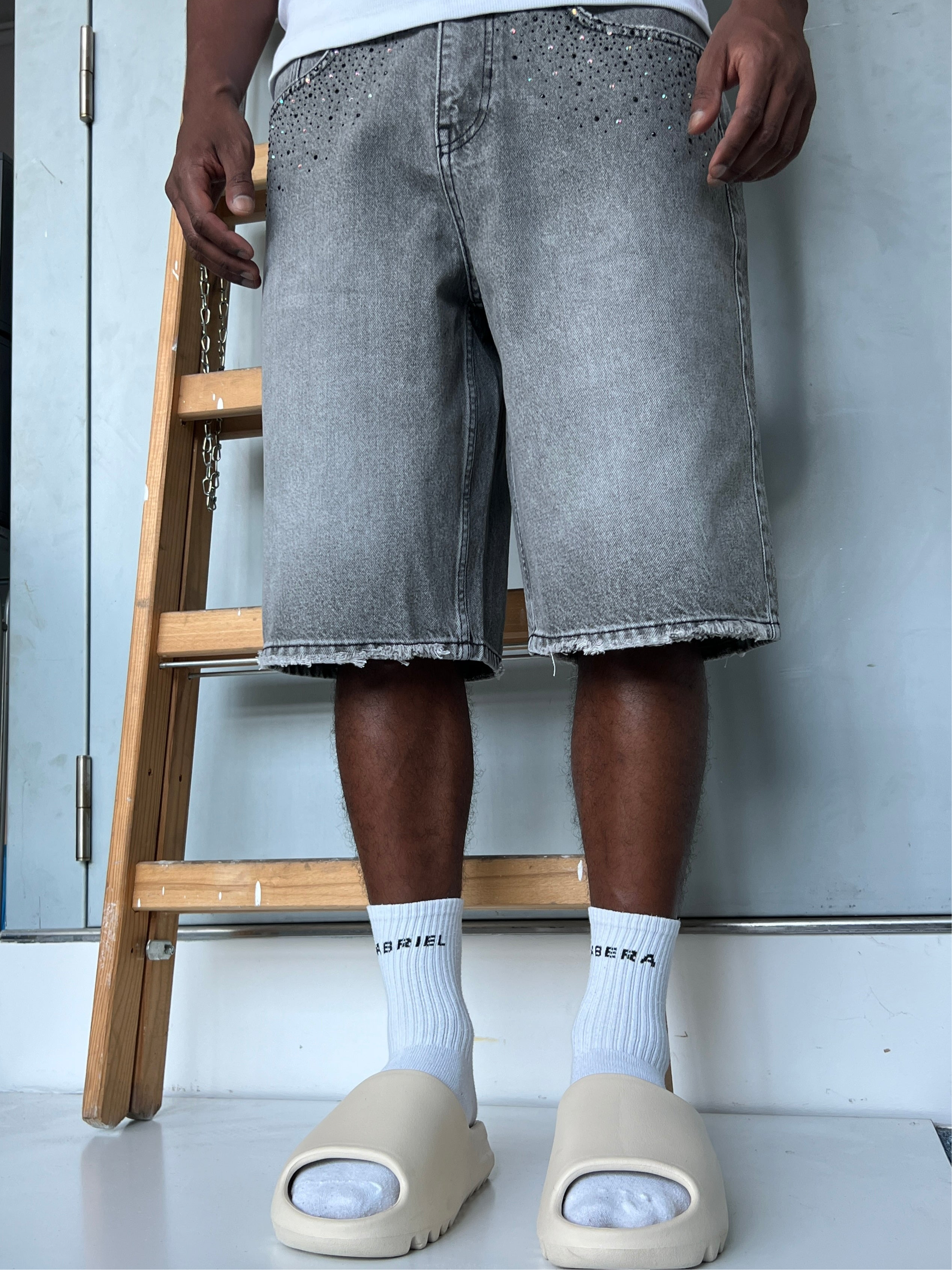 Front view of model wearing Gabriel Abera Rhinestones Denim Jorts, cropped at waist.