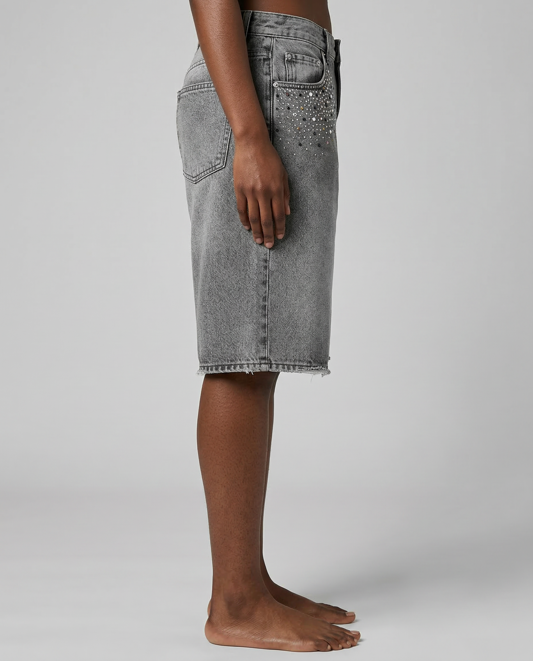 Side view of model wearing Gabriel Abera Rhinestones Denim Jorts, cropped at waist