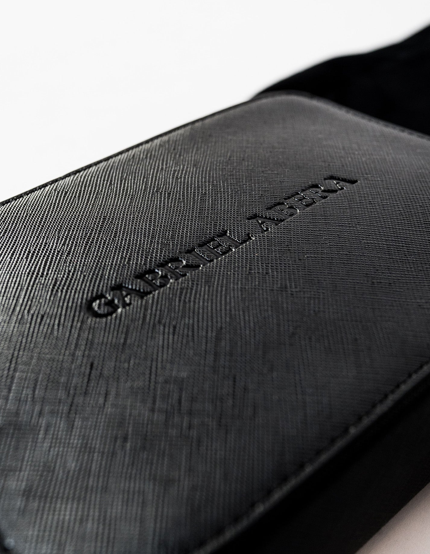 Close up of black Shoulder Bag with Gabriel Abera inprint