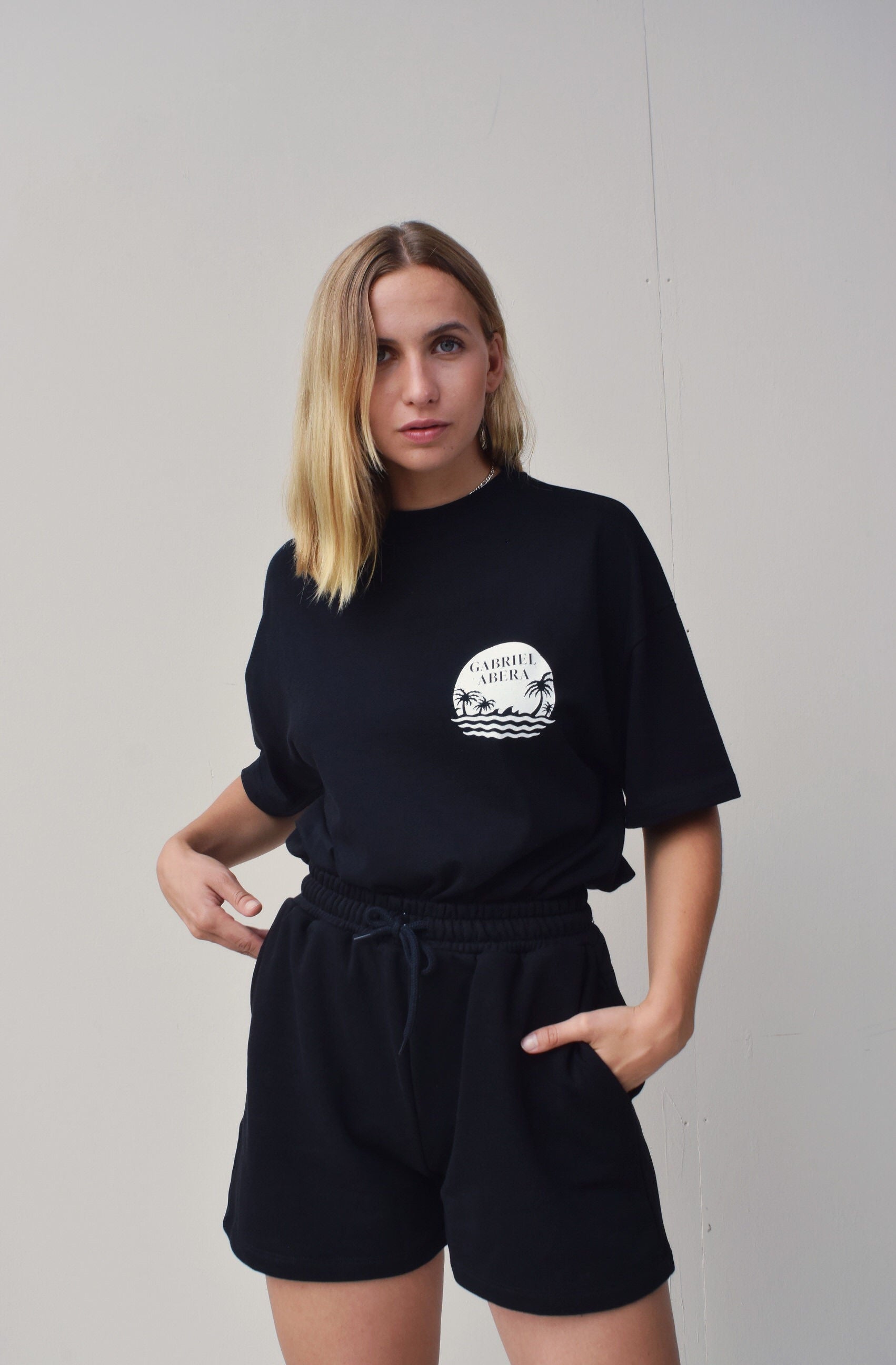 Female model wearing Black oversize Tshirt with round brand design