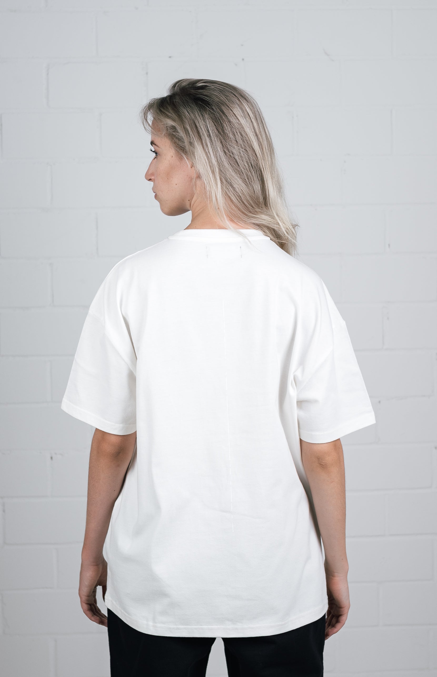 Female model wearing a White oversize tshirt