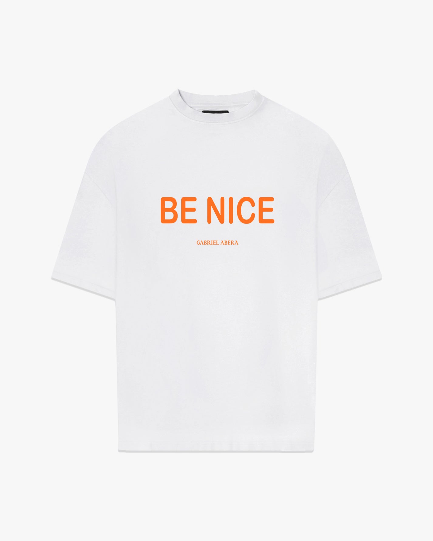 Male Model wearing White oversize tshirt with orange "be nice" print on the front 