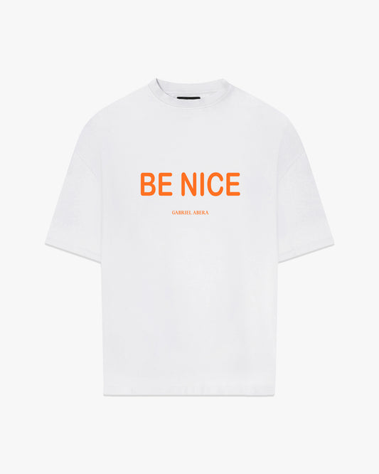Male Model wearing White oversize tshirt with orange "be nice" print on the front 