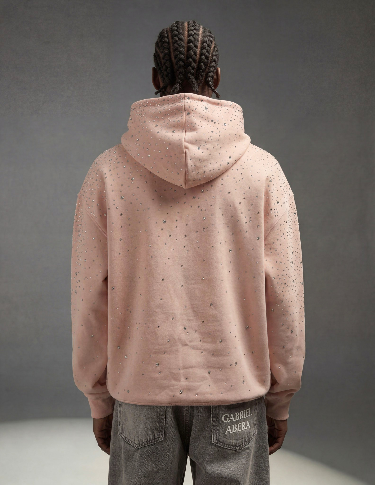 Male model back view rosa hoodie with Strasssteinen oversized fit with clean back and subtle crystal shine GABRIEL ABERA