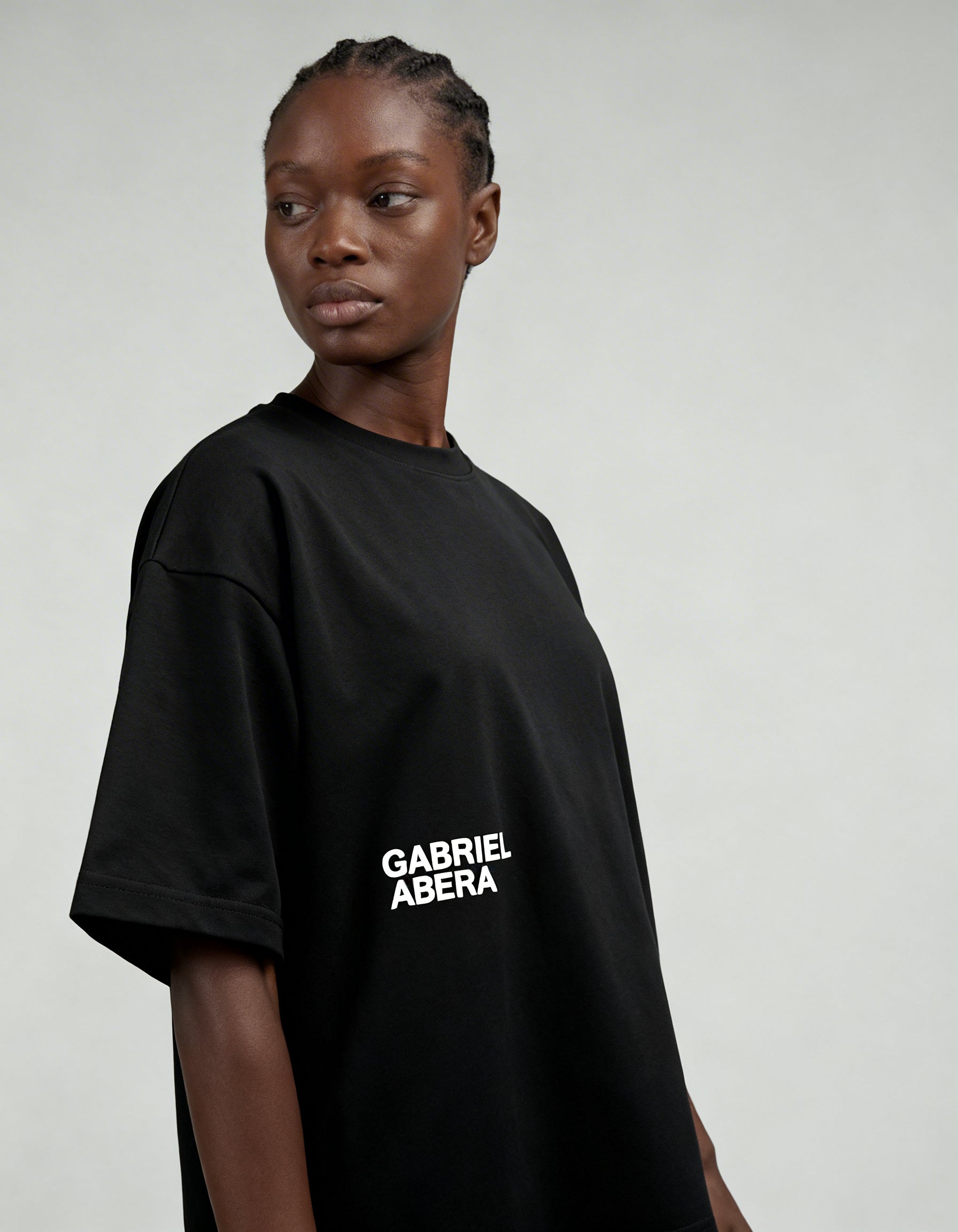 Black oversized logo T-shirt by GABRIEL ABERA worn by female model showing relaxed boxy streetwear fit.