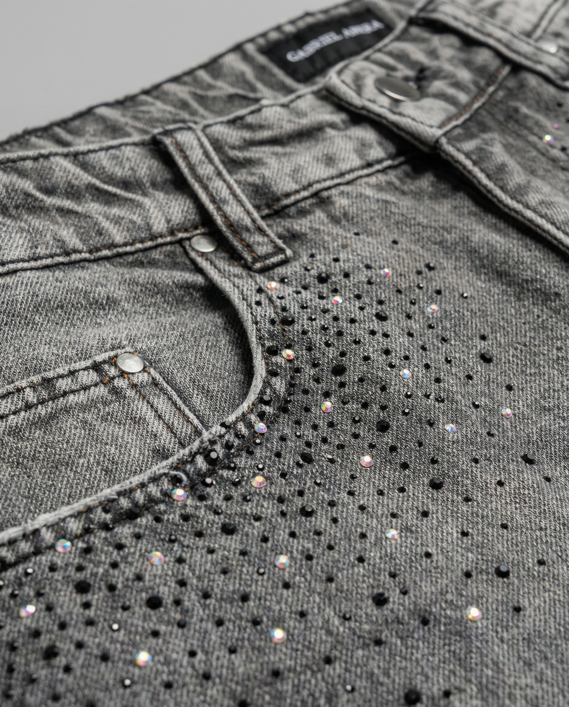 Close-up of rhinestone embellishment on Gabriel Abera Rhinestones Denim jorts.