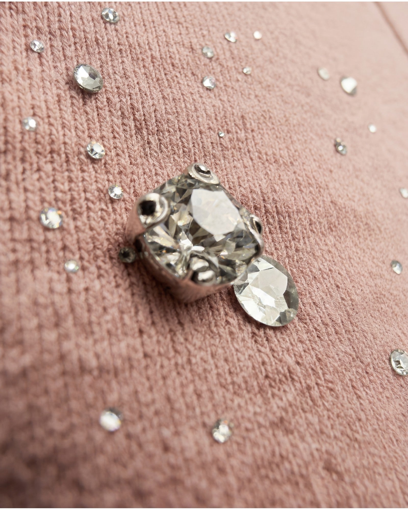 Close-up of hand-applied rhinestones / StrassSteinen on Gabriel Abera hoodie fabric showing premium crystal detailing and texture GABRIEL ABERA