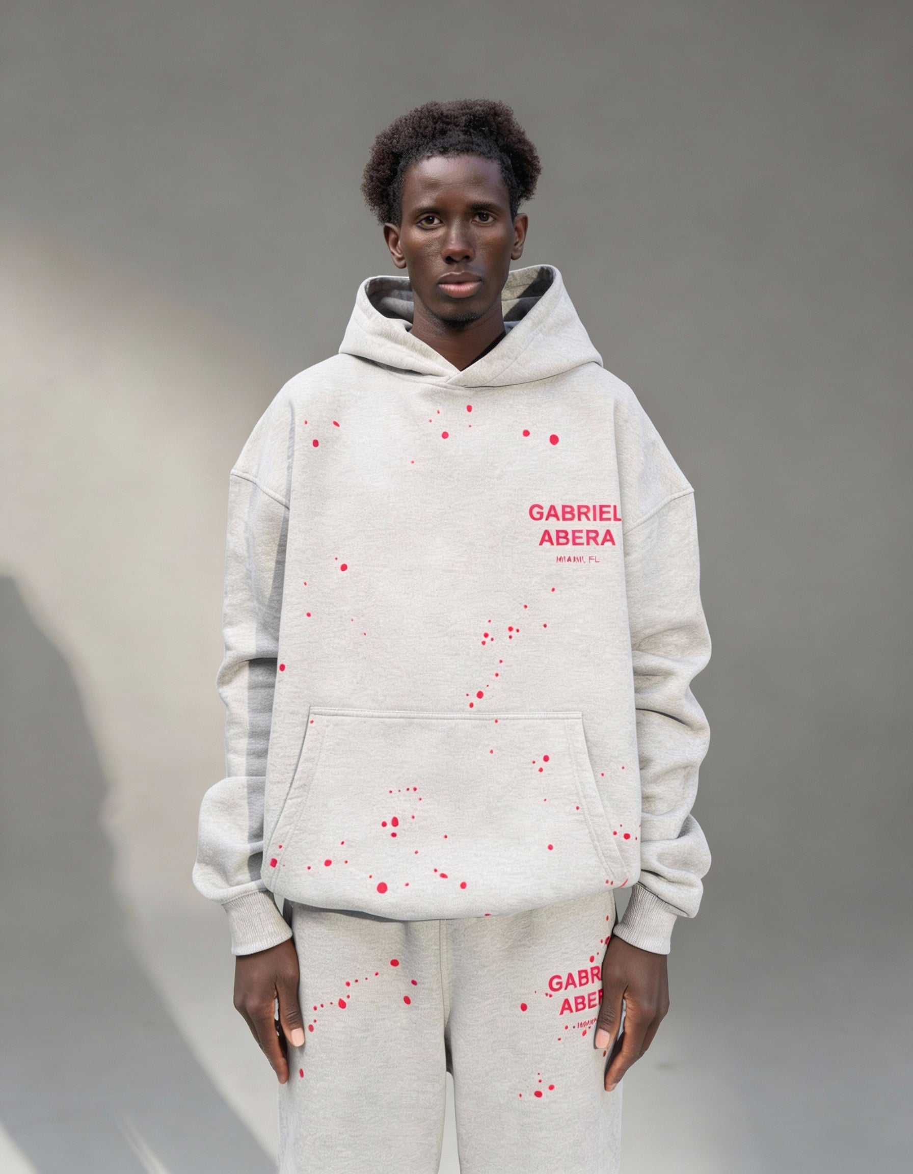 Front view of Grey Splattered Puff Hoodie with hand-painted details by Gabriel Abera, puff print, and oversized streetwear design.