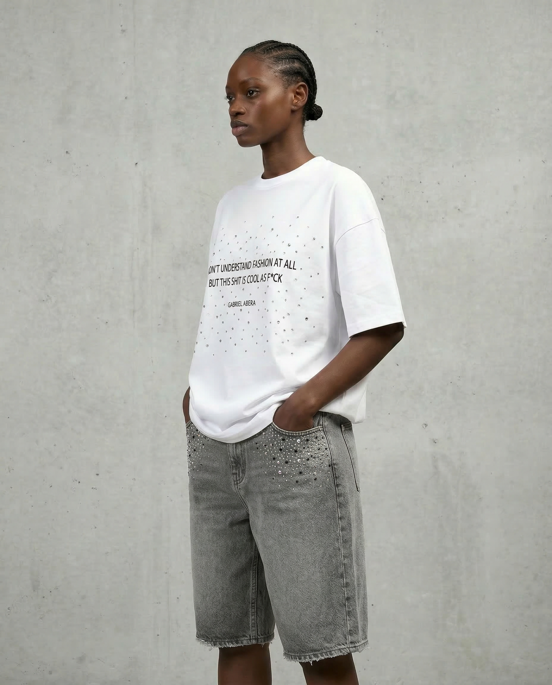 Full Side view of female model wearing Gabriel Abera Rhinestones Denim Jorts, cropped at waist