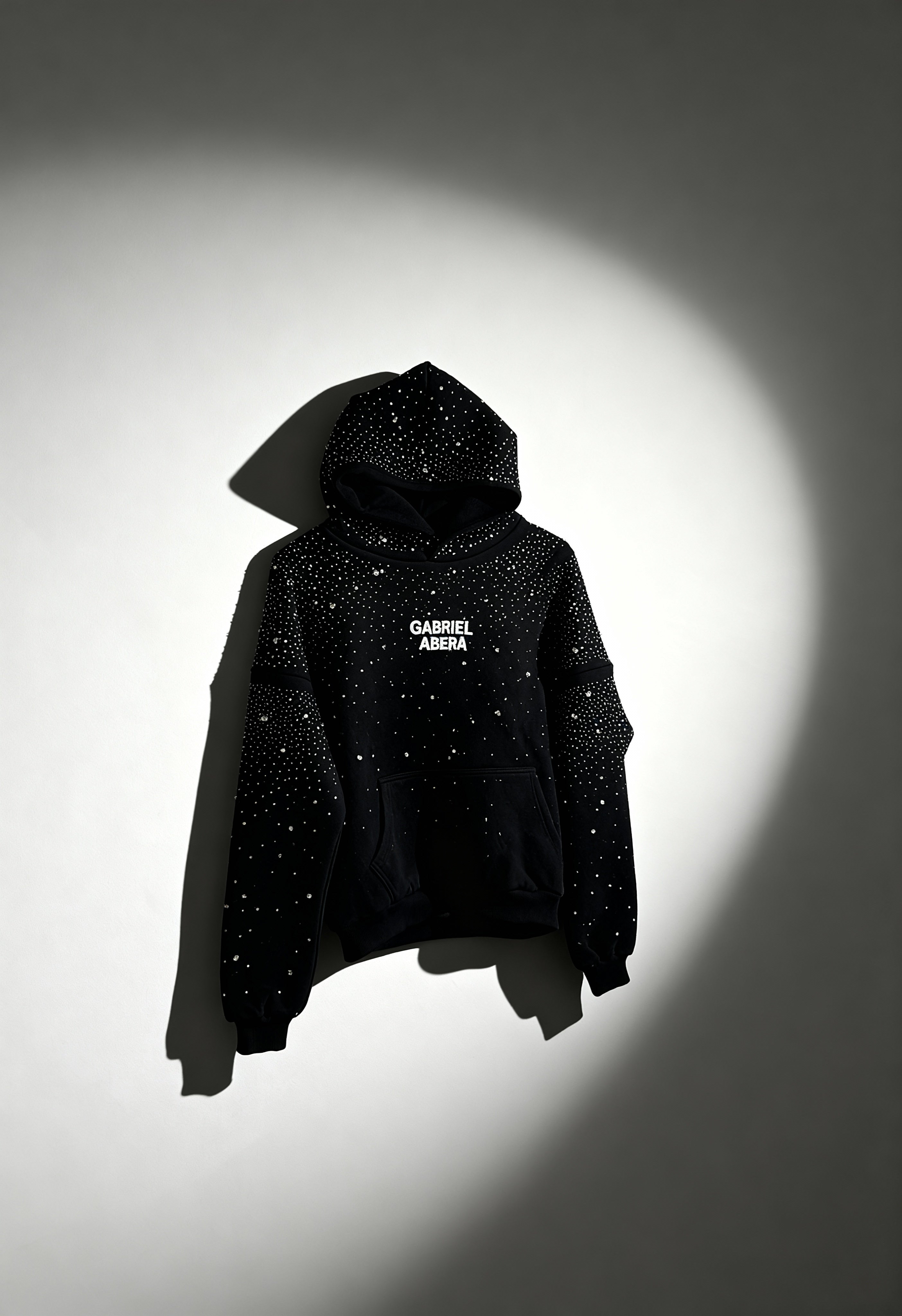 GABRIEL ABERA Rhinestone Hoodie schwarz – kreative Aufnahme mit Schatteneffekt, Rhinestone-Details glitzern, Premium Urban Streetwear Ästhetik