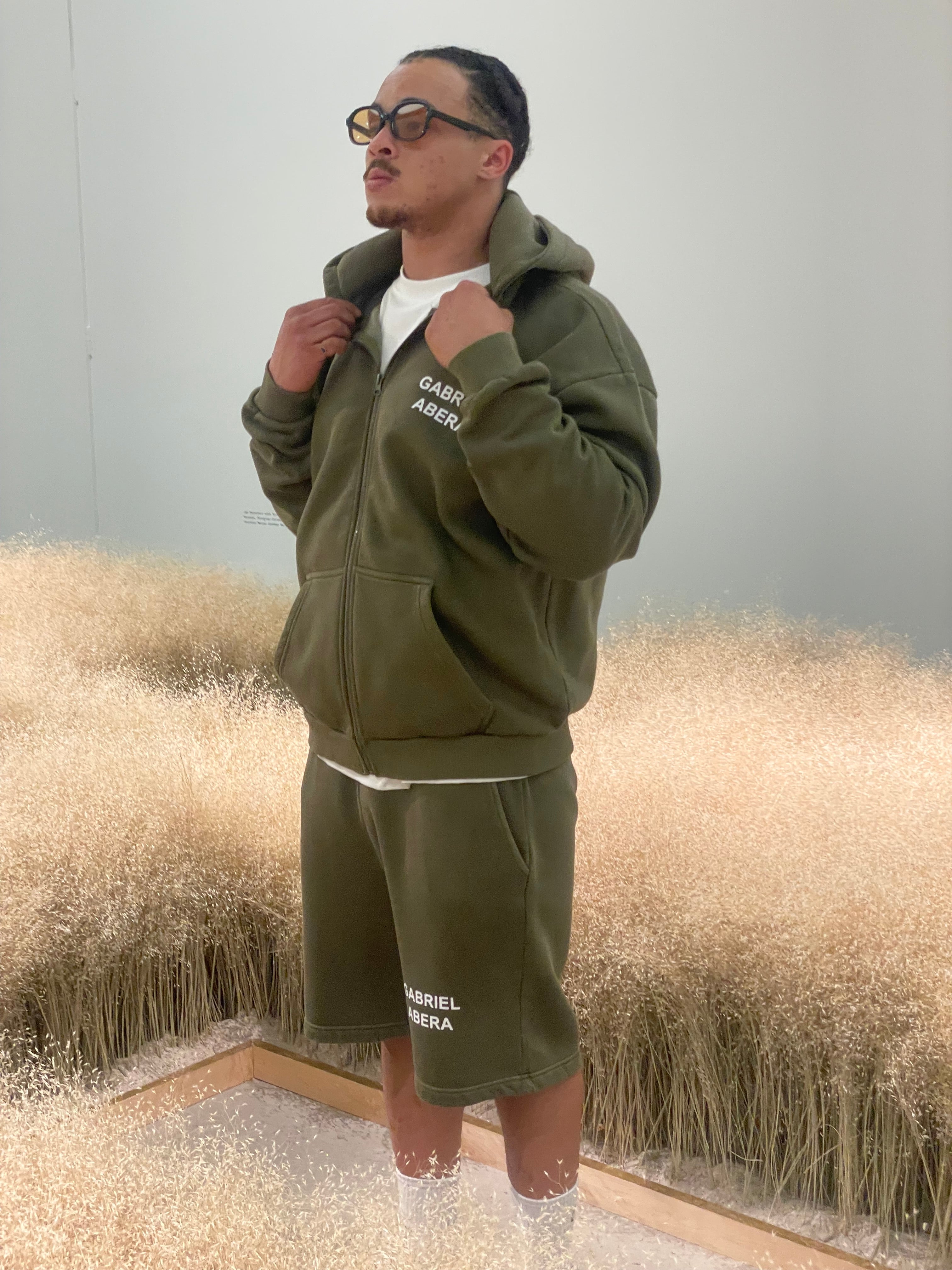 Model wearing olive shorts and zip hoodie – GA Logo print Basic