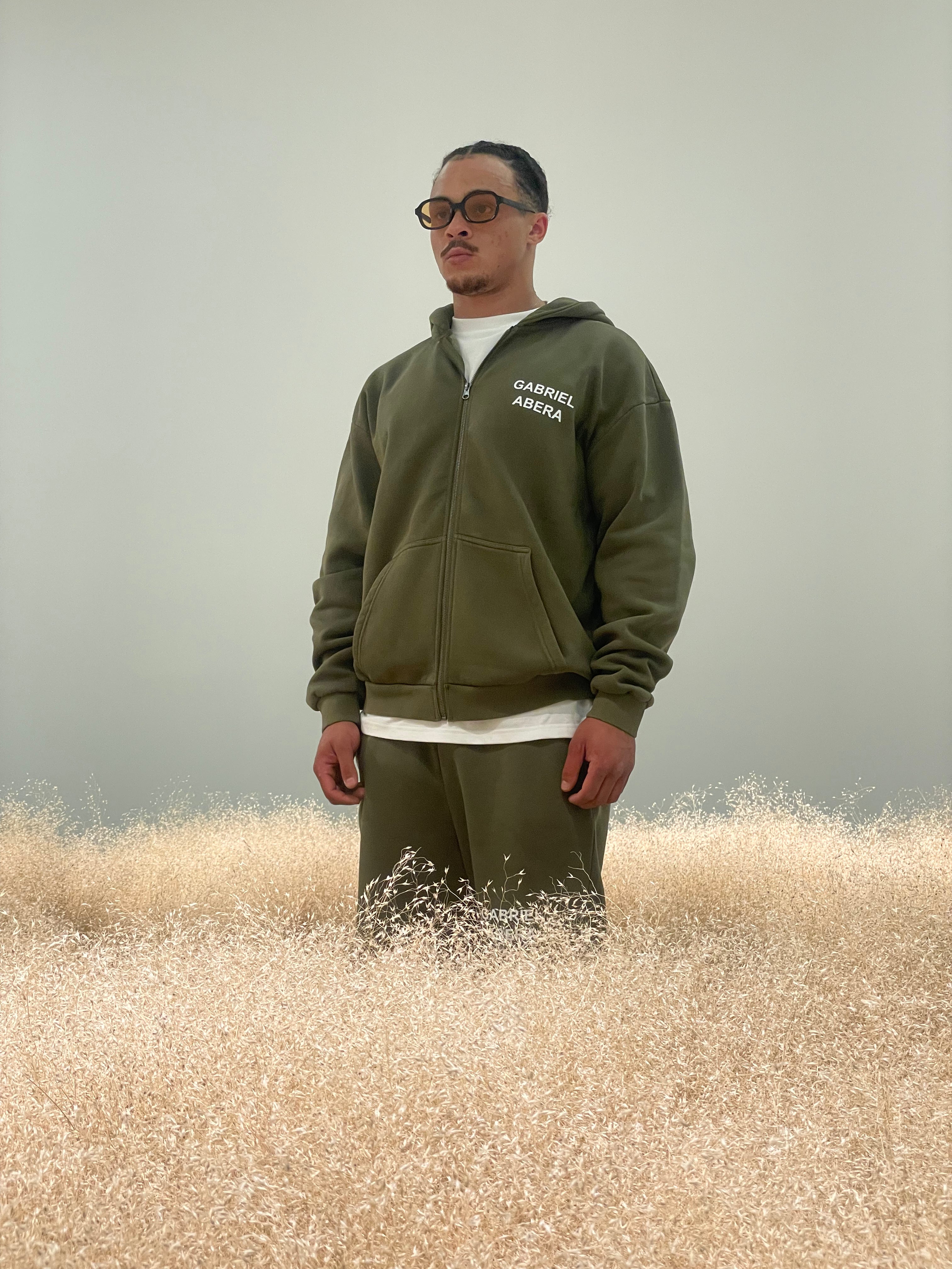 Model in olive Zipper and Shorts by Gabriel Abera