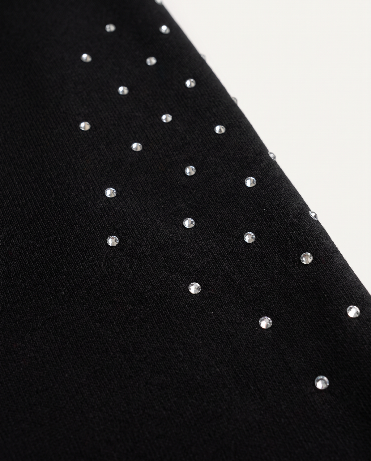 Nahaufnahme der handgesetzten Rhinestones und Strasssteine auf den schwarzen GABRIEL ABERA Astral Sweatpants