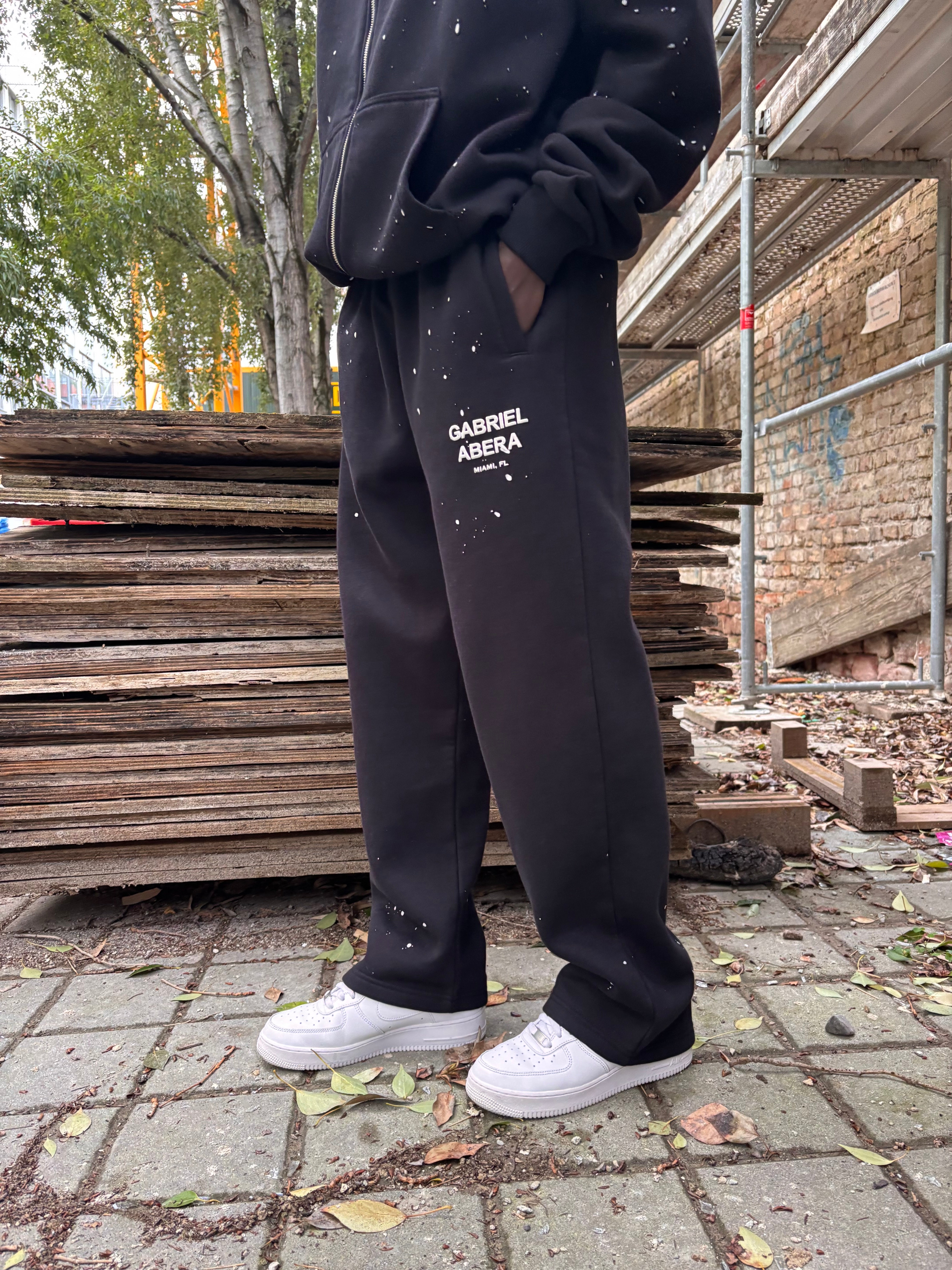 Seitenansicht der GABRIEL ABERA Splattered Sweatpants Black/White – lockerer Schnitt mit Splatter-Design.