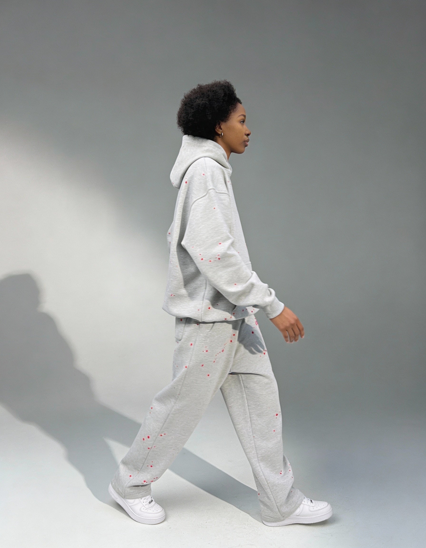 Side view of Grey Splattered Tracksuit with hand-painted details by Gabriel Abera, puff print, and oversized streetwear design.