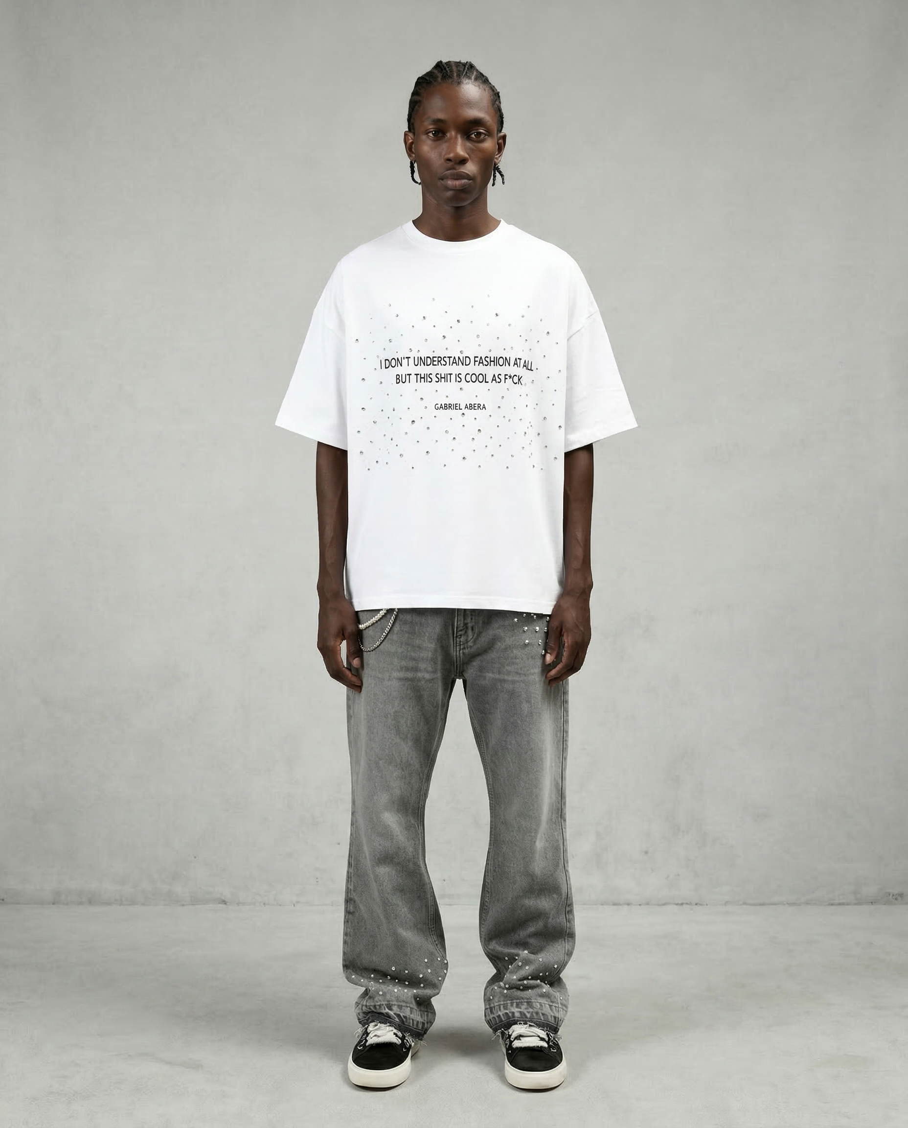White boxy rhinestone T-shirt by GABRIEL ABERA featuring statement text print and scattered rhinestone embellishments on the chest.