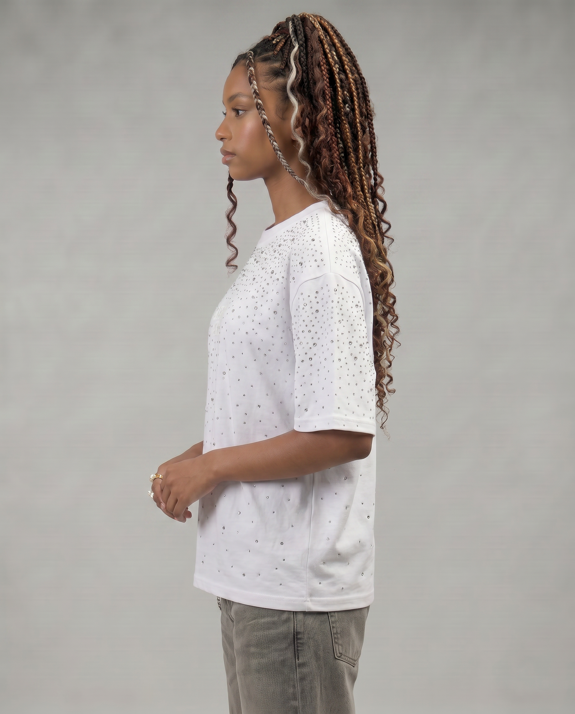 GABRIEL ABERA Rhinestone Universe Tee Off White – female model close-up, rhinestone embellishment detail on off-white fabric