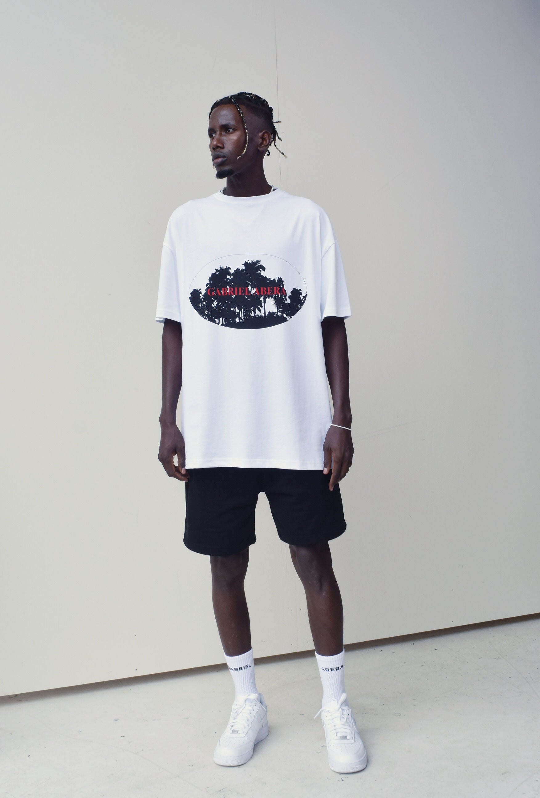Model wearing a White oversize tshirt with black and red summer design in the front 