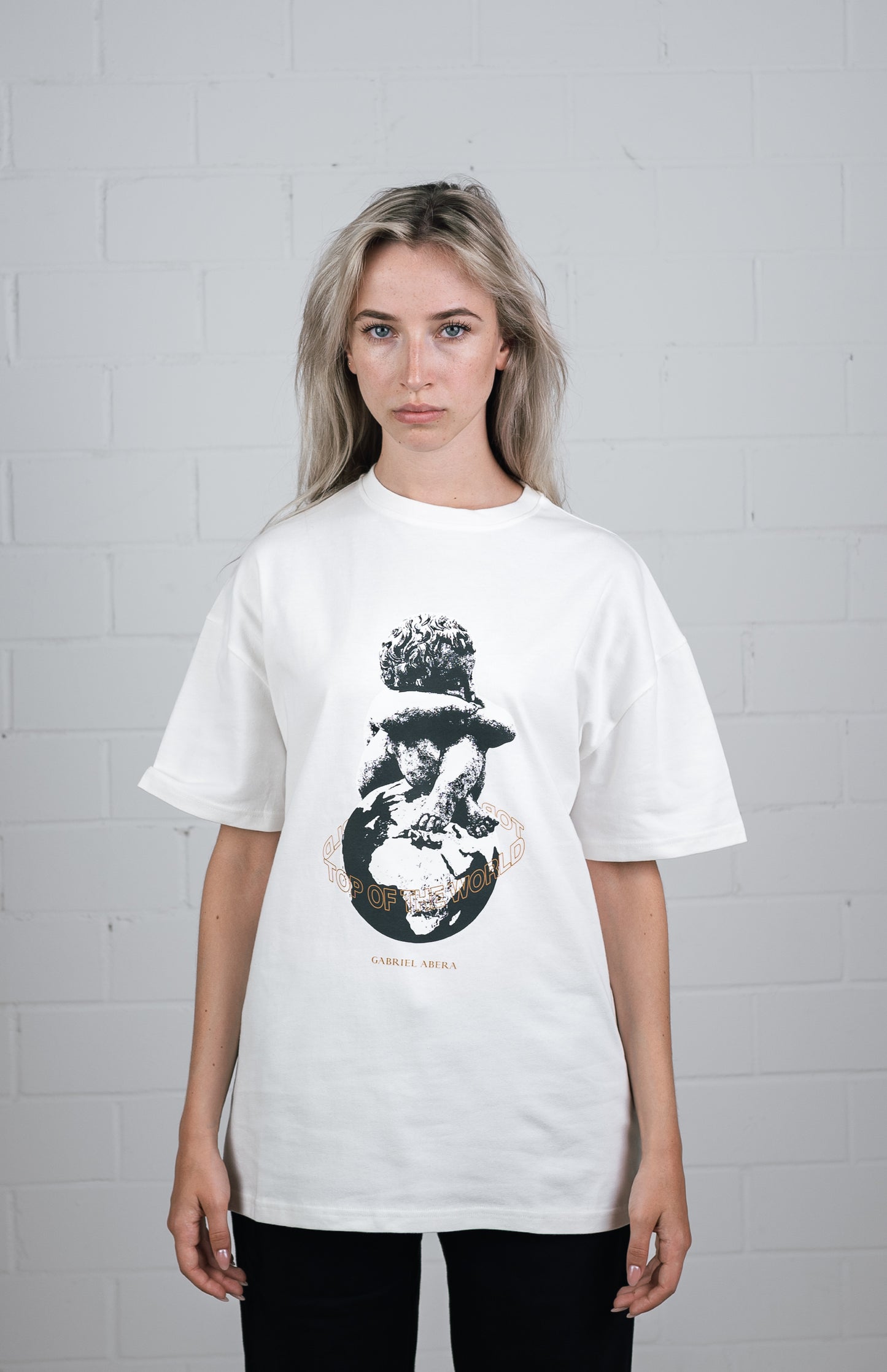 Female model wearing a White oversize t shirt with kid on globe design in the front