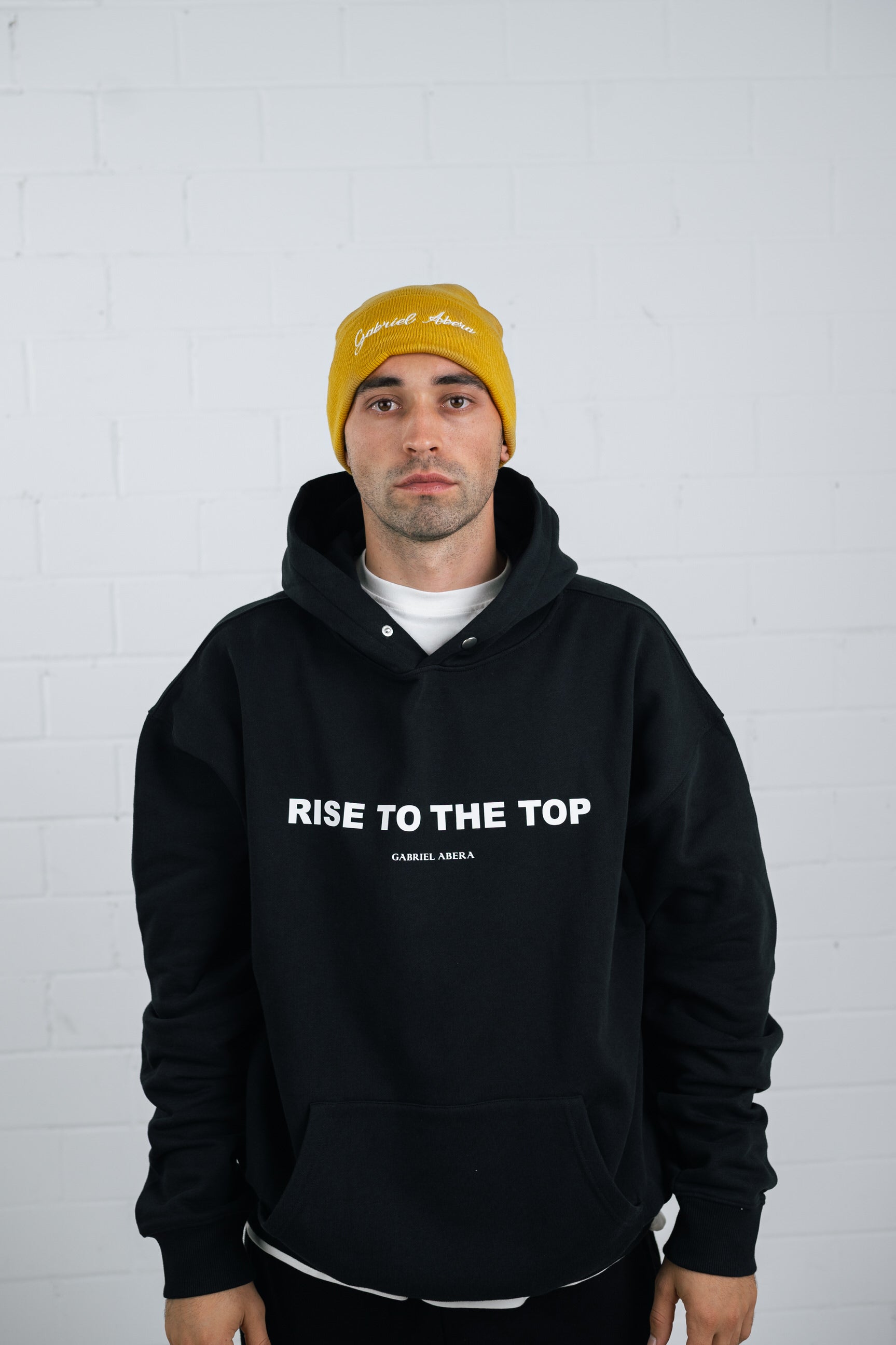 Male model wearing a Yellow beanie with brand name embroidery