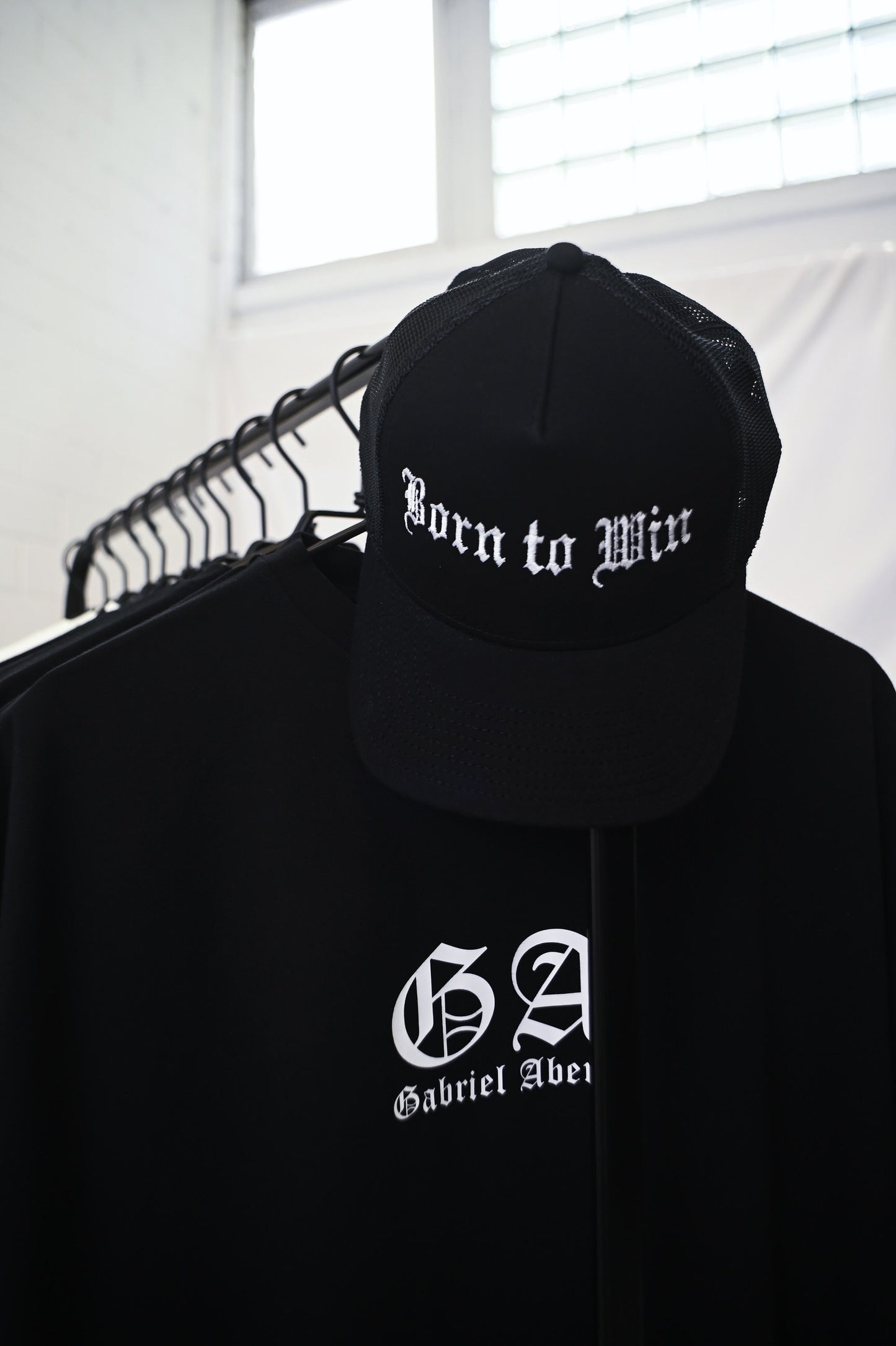 Black trucker cap with born to win embroidery