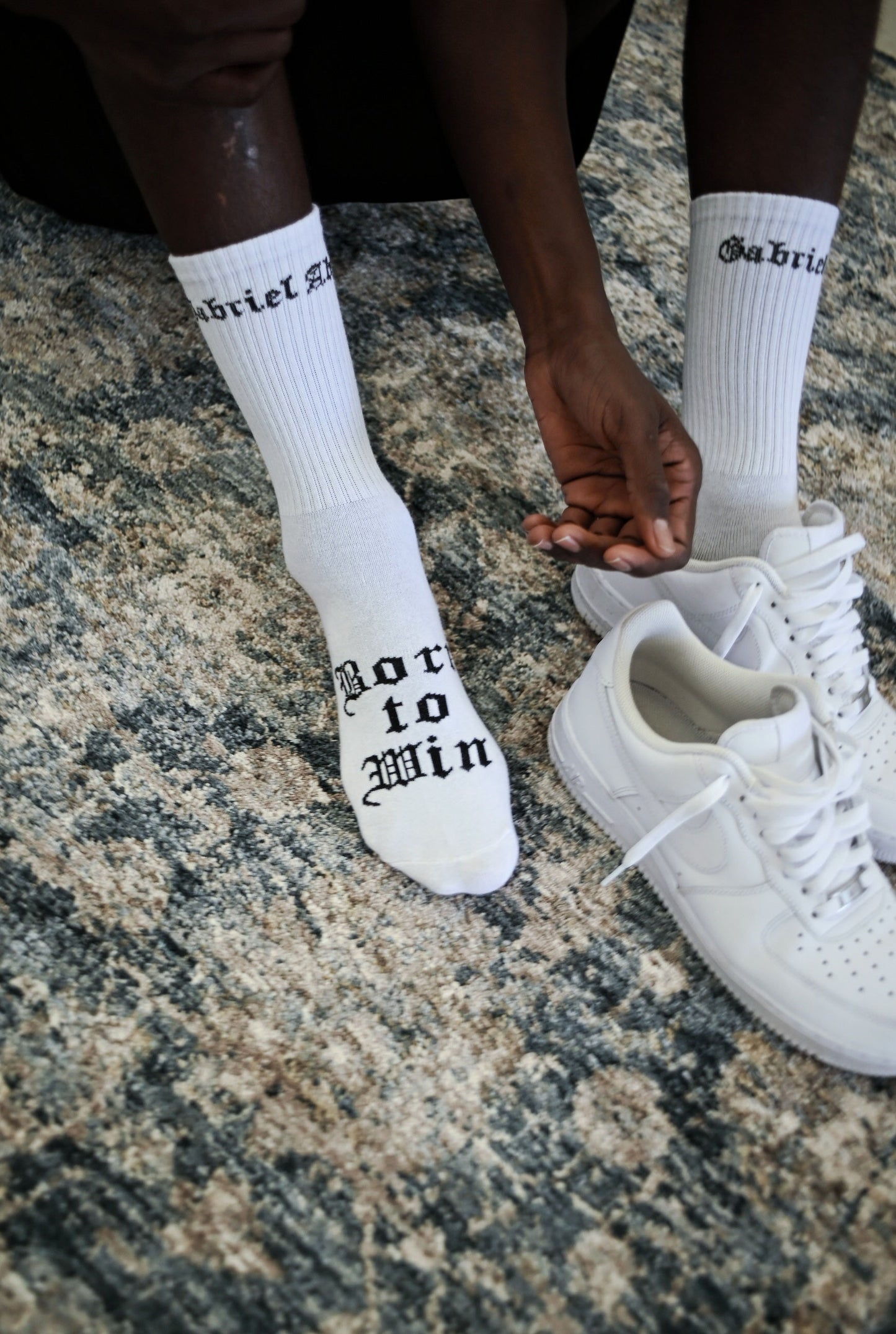 Model wearing A pair of white socks with brand design